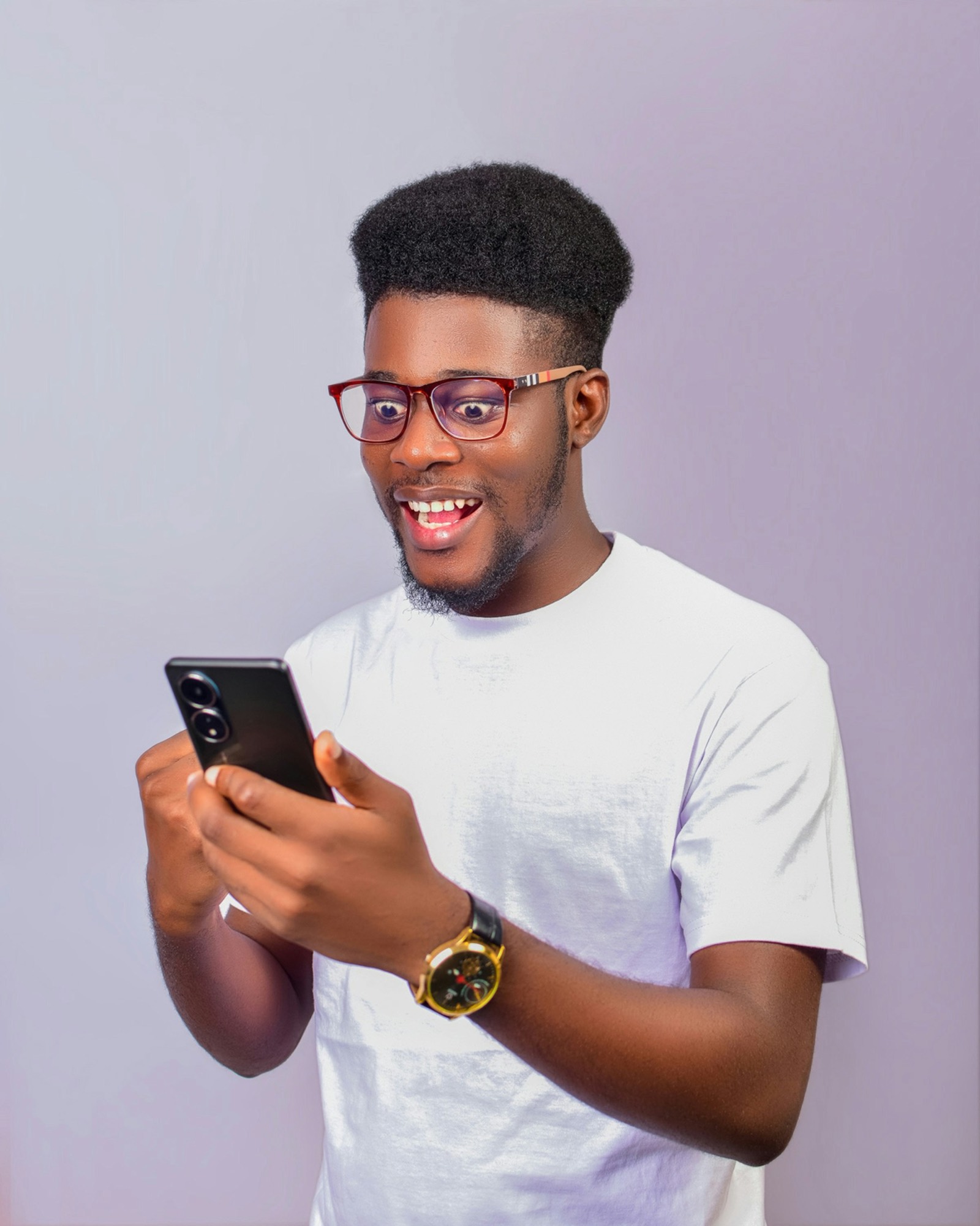 A man in glasses reading a message on his phone
